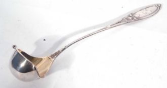 Continental white metal punch ladle in Art Nouveau taste, having Iris embossed pointed handle, the