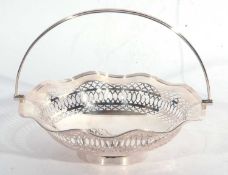 George V silver swing handled dish having a wavy reeded edge, the sides with pierced geometric