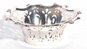 Edward VII silver bon-bon dish of circular form, scroll border with pierced geometric design