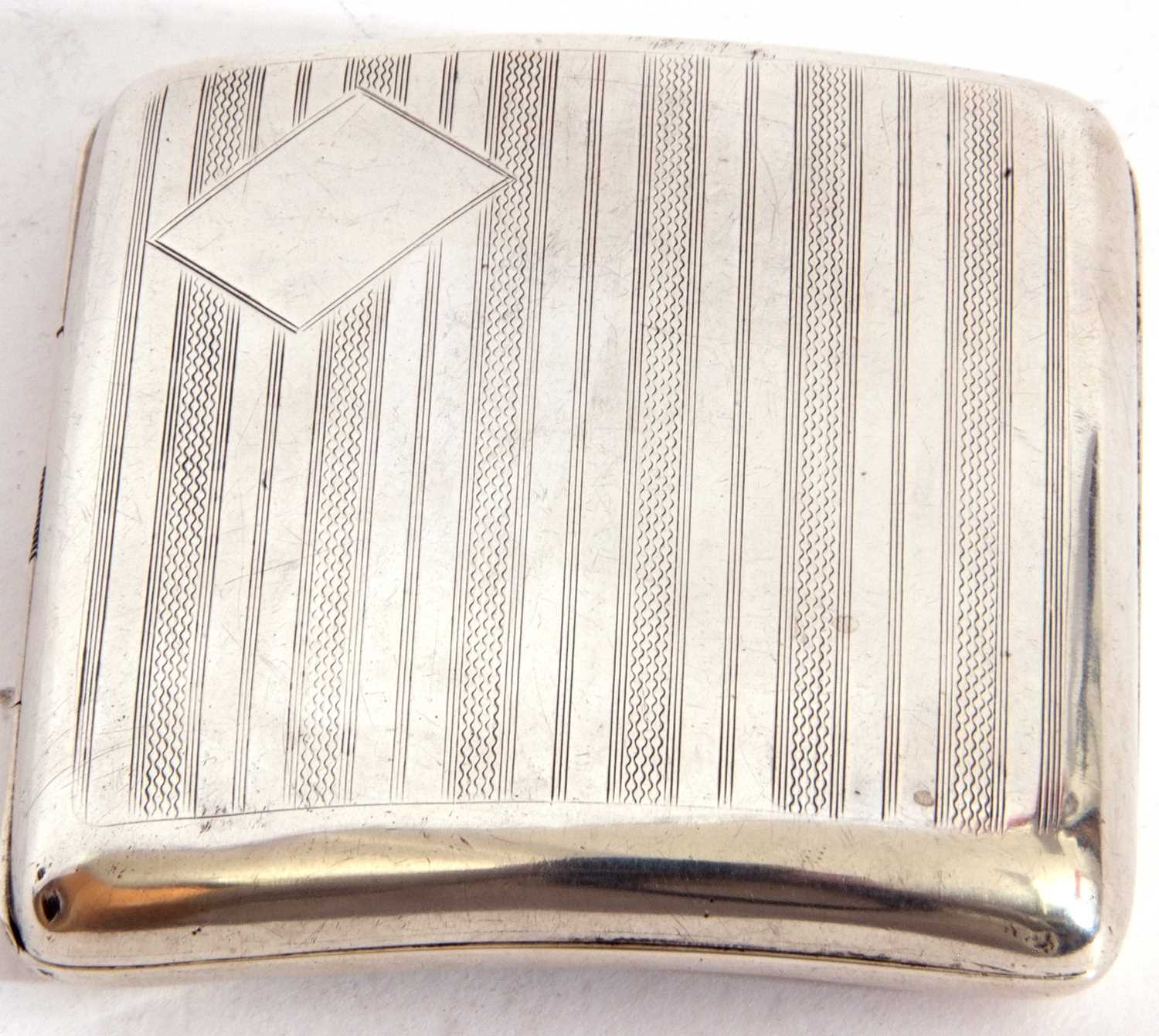 George V silver cigarette case of shaped square form, with engine turned decoration back and