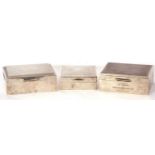 Mixed Lot: three silver mounted and wood lined cigarette boxes of hinged form, decorated with