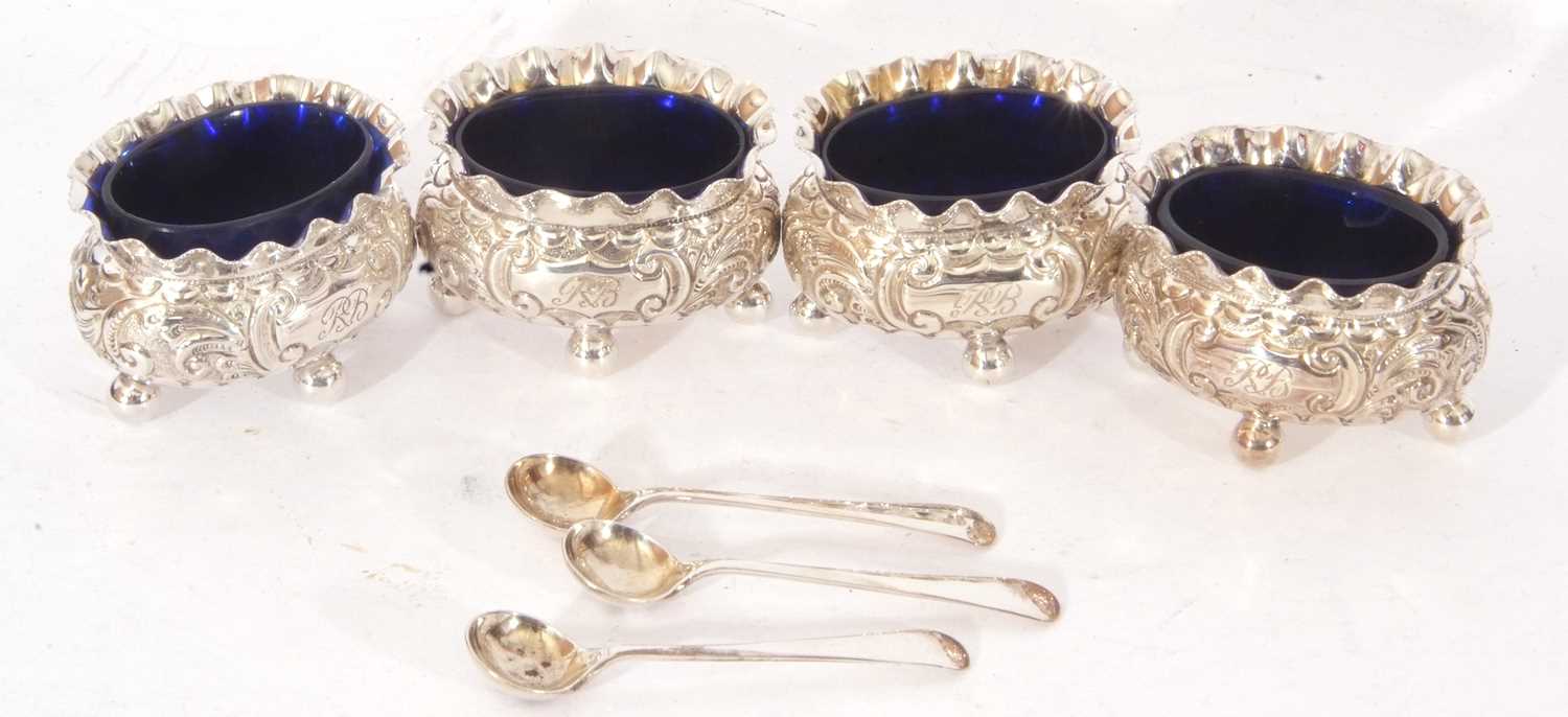 Set of four late Victorian silver four-footed salts of oval form with floral decoration and