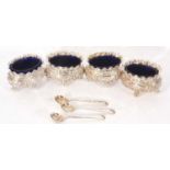 Set of four late Victorian silver four-footed salts of oval form with floral decoration and