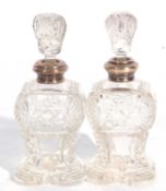 Pair of George V glass scent bottles and stoppers, each with a silver collar, London 1922, maker's