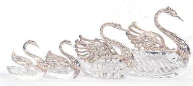 Group of four cut glass and white metal swan dishes featuring large, medium and a pair of small