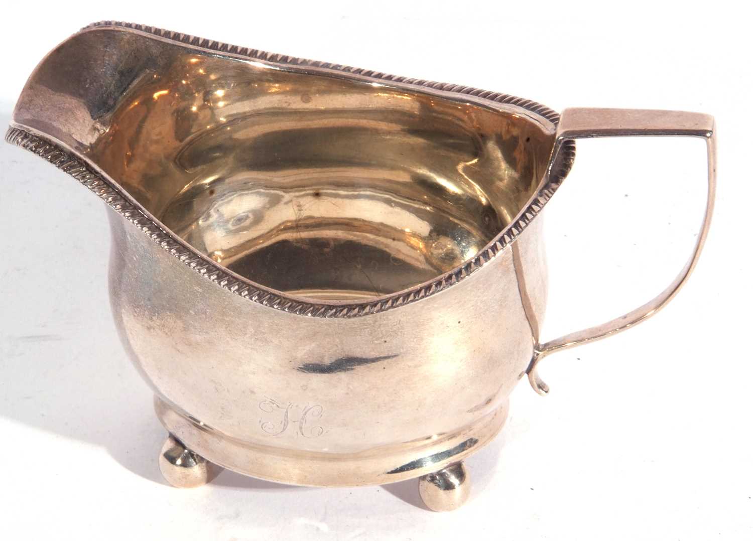 George III silver cream jug of plain form with gadrooned rim, angular looped handle, initialled - Image 2 of 2