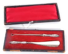 Victorian cased shoe horn and button hook, each with embossed silver handles, Birmingham 1897