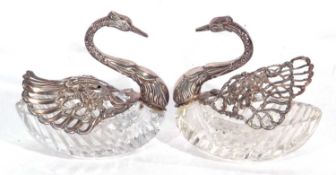 Pair of 925 marked glass 'Swan' butter dishes, the cut glass bodies with mounted swan heads and