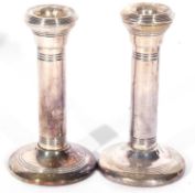 Pair of George V silver candlesticks of plain form with reeded decoration (loaded), Birmingham 1915,