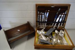 CANTEEN OF SILVER PLATED CUTLERY TOGETHER WITH A SLIDING OAK BOOK RACK