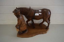 20TH CENTURY CARVED WOODEN MODEL OF MAN WITH SHIRE HORSE, INITIALS TO THE BASE 'AW'