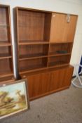 MID-CENTURY TEAK CABINET WITH SHELVED TOP SECTION OVER A TWO-DOOR BASE, 134CM WIDE