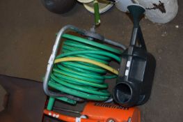 ROLL OF HOSEPIPE AND A WATERING CAN