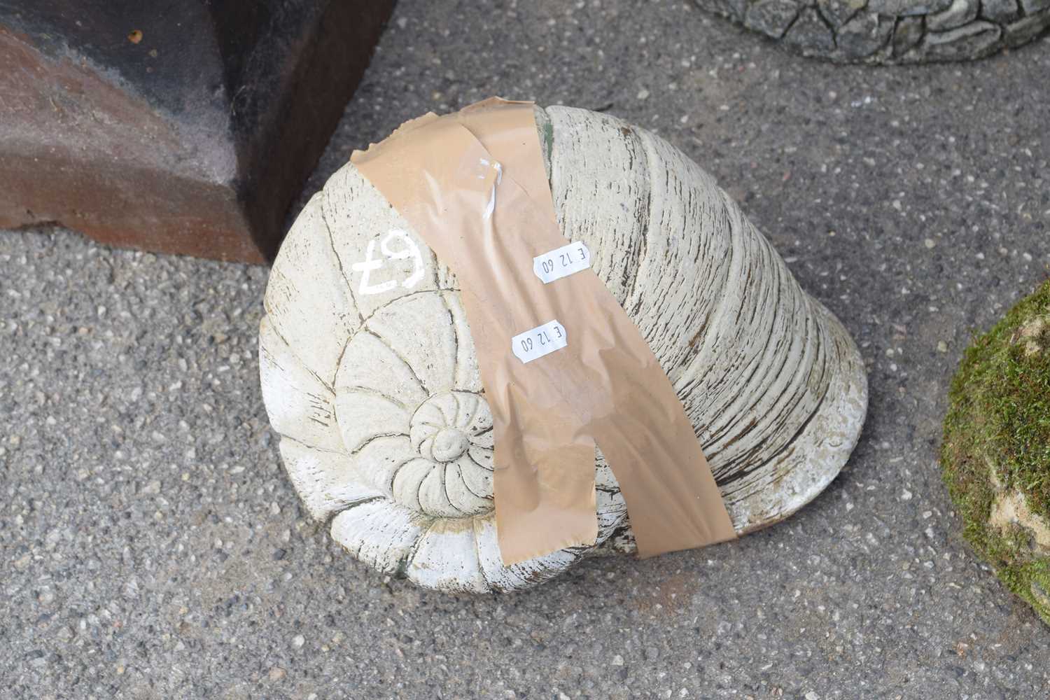 Composite garden ornament in the shape of a shell