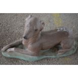 Composite garden ornament modelled as a dog, length approx 65cm