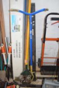 Quantity of garden tools to include rakes, cultivators, and a vintage spirit level