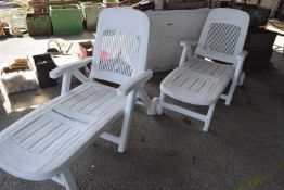 Pair of plastic sun loungers