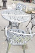 Cast metal bistro garden set comprising a table and two chairs