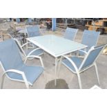 Large metal and glass garden table with six chairs and two side tables