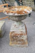 Stone garden urn on a plinth, total height 70cm, width 45cm