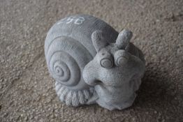 Composite garden ornament formed as a snail, approx 25cm x 30cm