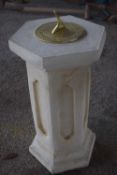 Composite formed plinth with a brass sundial on top, height approx 55cm