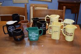 Collection of 11 various Wade pub jugs with a variety of designs