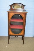 Edwardian mahogany and inlaid music cabinet with mirrored back and single door with oval glazed