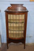 Edwardian mahogany and inlaid china cabinet with bow front lead glazed door, raised on tapering