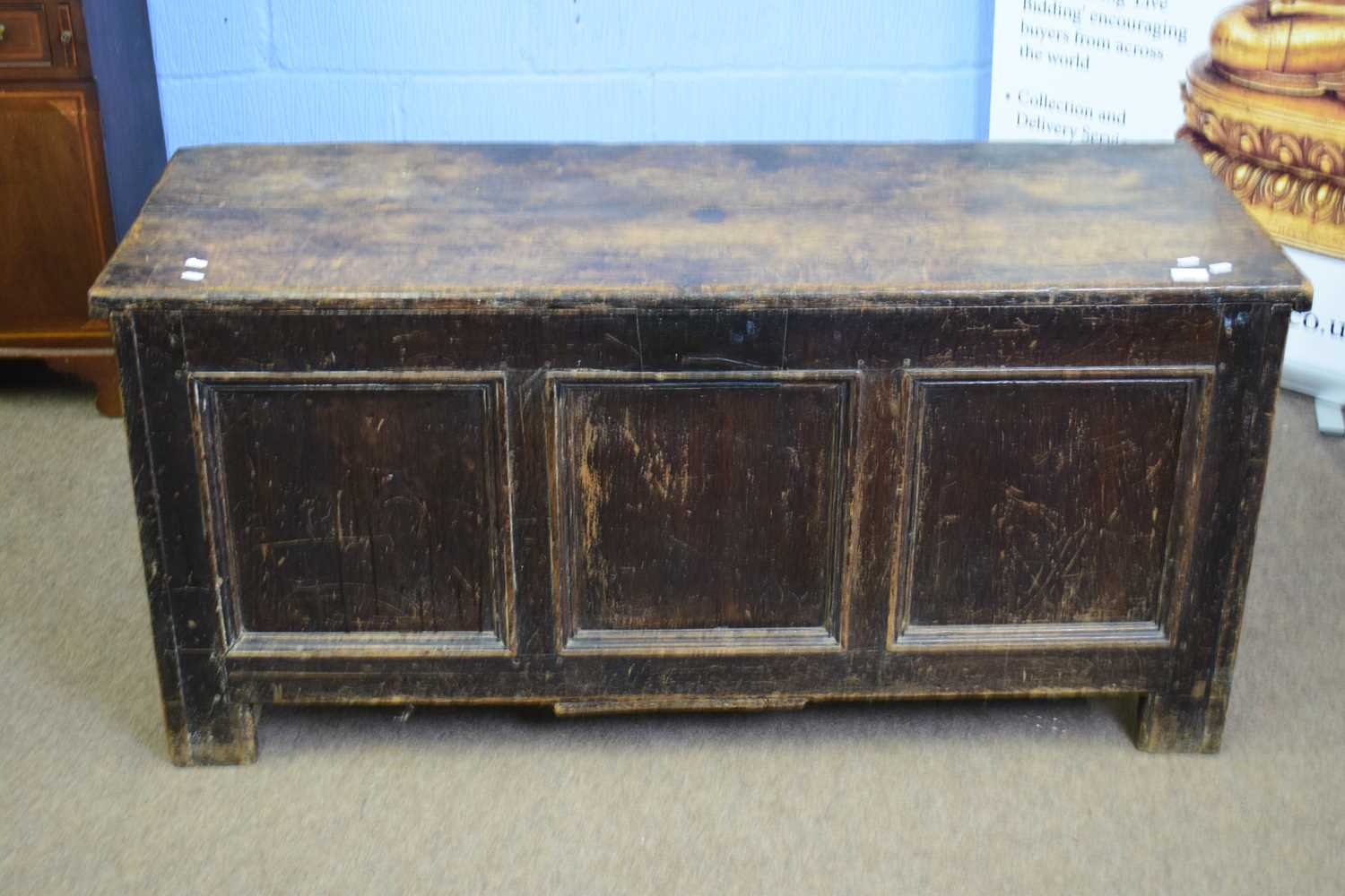 18th century oak coffer with board top over three panelled front raised on short stile feet, 134cm
