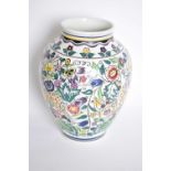 A Poole pottery vase the baluster body with a pattern of deer amongst geometric flowers (restored)