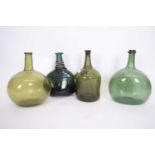 Group of four 18th century green glass bottles including a Pyrmont water bottle with seal, two