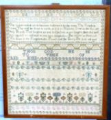 18th century needlework sampler decorated with extensive rows of religious text, numbers and