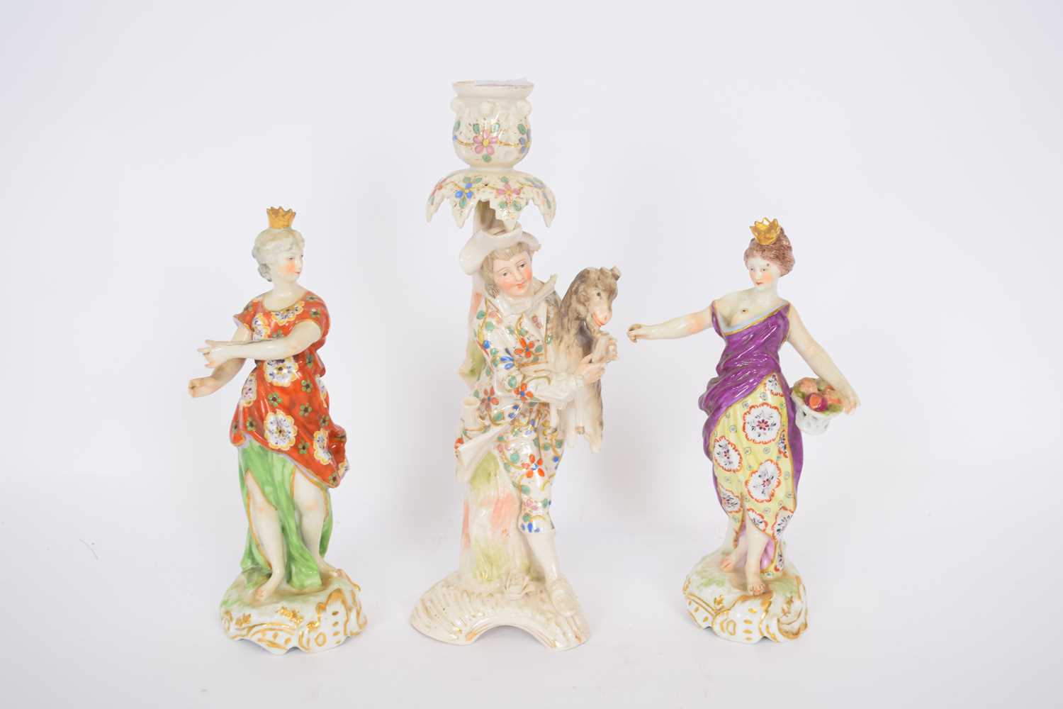 Continental porcelain candlestick of gentleman holding a goat and two Chelsea style figures (3)