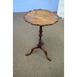 Small mahogany wine table with shaped top over a turned column and tripod base, 73cm high (a/f)