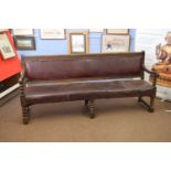 Victorian oak framed railway bench with upholstered seat and back, raised on bobbin turned legs,
