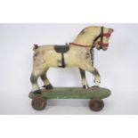 Small wooden toy of a horse, on a rectangular base