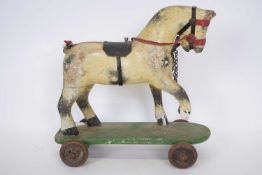 Small wooden toy of a horse, on a rectangular base