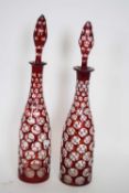 Pair of decanters with tear drop stoppers in Bohemian style with ruby overlay