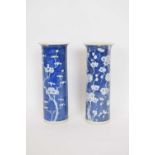 Chinese porcelain vase, the cylindrical body with blue ground and prunus decoration, together with a