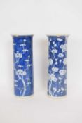 Chinese porcelain vase, the cylindrical body with blue ground and prunus decoration, together with a