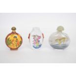 Small bag containing three Chinese scent bottles including a porcelain example with polychrome