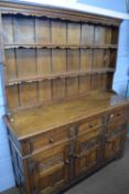 Good quality reproduction oak dresser with moulded cornice and two shelves to back over a base
