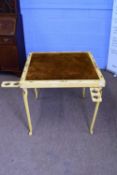 Early 20th century painted travelling games table with fold-in cabriole legs and a fabric covered