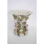 Large late 19th century Continental porcelain centrepiece, the bowl supported by three cherubs on