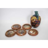 Gouda jug with floral design together with five pot lids in wooden frames (qty)