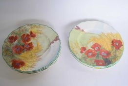 Group of eight Royal Doulton plates in a poppy pattern