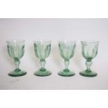 Set of four green glass 19th century wine glasses, the faceted bowls on baluster stems (4)