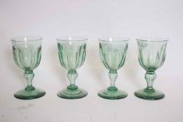 Set of four green glass 19th century wine glasses, the faceted bowls on baluster stems (4)