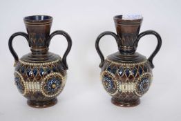 Pair of 19th century Doulton stoneware vases with loop handles and incised designs (2)